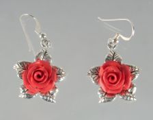 A PAIR OF SILVER AND CORAL ROSE EARRINGS.