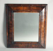 A GOOD 18TH CENTURY WALNUT CUSHION FRAMED MIRROR. 1ft 11in high, 1ft 8ins wide.