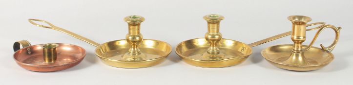 A PAIR OF LONG HANDLED BRASS CHAMBER STICKS and two others. (4).