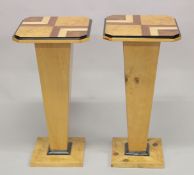 A PAIR OF ART DECO STYLE INLAID SQUARE TOP PEDESTAL STANDS on tapering supports and square bases.