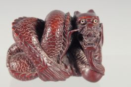 A CARVED WOOD DRAGON NETSUKE 2ins