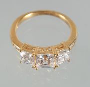 A SILVER THREE STONE C Z RING.