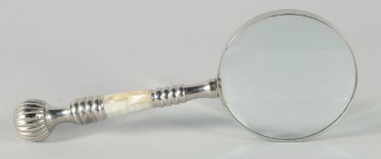 A MAGNIFYING GLASS with a chrome and mother of pearl handle.