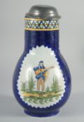 A LARGE DELFT POTTERY JUG with pewter cover painted with a panel of a man playing a guitar. 11ins