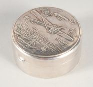 A SILVER CIRCULAR PILL BOX, plane and boat 1.75ins diameter.