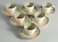 A SET OF SIX APPLE GREEN AND GILT FLORAL CUPS AND SAUCERS.