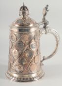 A GOOD VICTORIAN CONTINENTAL PLATED TANKARD AND COVER set with various coins.