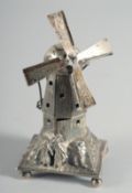 A MINIATURE SILVER WINDMILL on a square base with bun feet. 4ins high