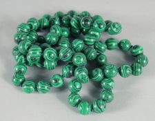 A STRING OF MALACHITE BEADS.