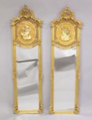 A GOOD PAIR OF LOUIS XVI GILDED NARROW LONG MIRRORS with scrolls and female portrait. 6ft high 1ft