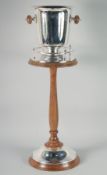 A TWO HANDLED WINE COOLER on a wooden stand. 34ins high overall.