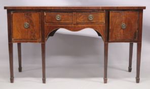 A GEORGE III MAHOGANY SERPENTINE FRONTED SIDEBOARD with crossbanded top, central drawer formed as
