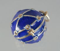 A SILVER AND BLUE ENAMEL BALL PENDANT. .75ins