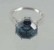 A SILVER BLUE STONE RING.