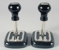A PAIR OF GEAR STICK PAPERWEIGHTS. 7ins high.