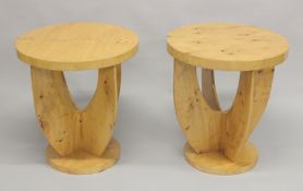 A PAIR OF ART DECO CIRCULAR TABLES with curving supports and circular bases. 1ft 11ins diameter, 2ft