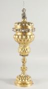 A GOOD CONTINENTAL SILVER GILT CHALICE AND COVER of 17th Century design, with bands of silver