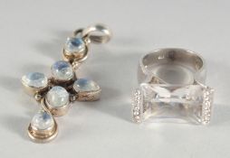 A SILVER AND MOON STONE CROSS AND RING.