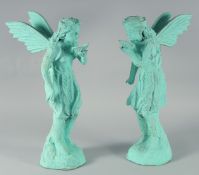 A PAIR OF PAINTED CAST IRON FAIRIES 19ins high.