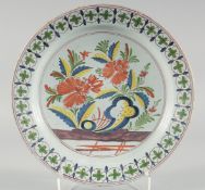 A GOOD 18TH CENTURY DUTCH FAIENCE POLYCHROME PLATE painted with flowers. 14ins diameter.