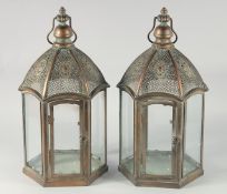 A PAIR OF TIN ISLAMIC PATTERN OCTAGONAL LANTERNS 20ins high.