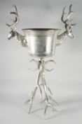 A STAG WINE COOLER on a plated antler base. 3ft 6ins high.