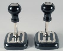 A PAIR OF GEAR STICK PAPERWEIGHTS. 7ins high.