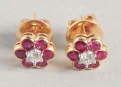 A PAIR OF 18CT YELLOW GOLD, RUBY AND DIAMOND FLOWER EARRINGS.
