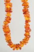 AN AMBER NINETY SIX BEAD NECKLACE.