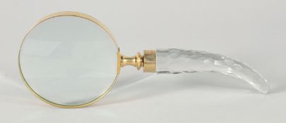 A MAGNIFYING GLASS with a cut glass curving handle.