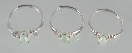 THREE SILVER AND JADE RINGS.