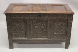 A GOOD 19TH CENTURY OAK DOWER CHEST with plain rising top, three carved panels to the front. 4ft