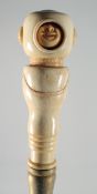 A CARVED BONE MOVING HEAD HANDLED WALKING STICK.