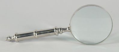 A MAGNIFYING GLASS with a chrome handle.