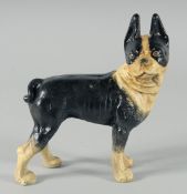 A PAINTED CAST IRON DOG DOORSTOP. 6.5ins long.