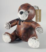 A TEDDY BEAR LEATHER AND CLOTH DOORSTOP.