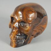A CARVED TIGER'S EYE SKULL. 3.5ins high.
