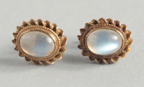 A PAIR OF GOLD AND MOON STONE OVAL EARRINGS.