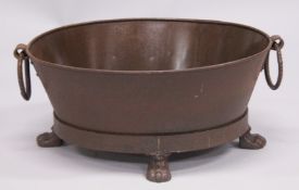 A SMALL OVAL METAL PLANTER on claw and ball feet. 26ins wide.