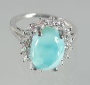A SILVER AND TURQUOISE CLUSTER RING.