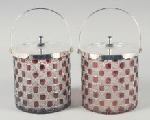 A PAIR OF CUT GLASS AND PLATED BISCUIT BARRELS.