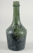 AN EARLY GLASS WINE BOTTLE.