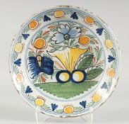 A GOOD 18TH CENTURY DUTCH FAIENCE POLYCHROME PLATE painted with flowers. 14ins diameter.