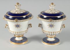 A PAIR OF WORCESTER URN SHAPED VASES AND COVERS, blue and gilt on a white ground. One marked