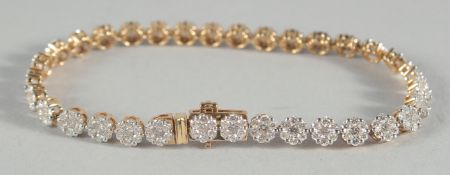 AN 18CT GOLD AND DIAMOND BRACELET.