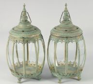 A PAIR OF ISLAMIC PATTERN BULBOUS LANTERNS on four feet. 20ins high.