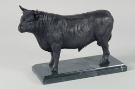 A BRONZE BULL on a marble base. 9ins long