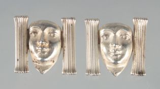 A PAIR OF SILVER MASK CUFF LINKS.