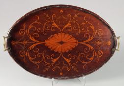 A GOOD EDWARDIAN MAHOGANY INLAID OVAL TEA TRAY with brass handles. 22ins long.