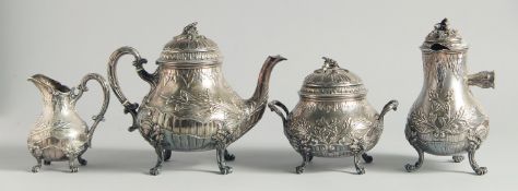 A VERY GOOD VICTORIAN SILVER FOUR PIECE TEA SET with floral repousse decoration, shells supported on